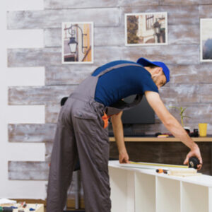 Furniture assembly worker standing reading instruction